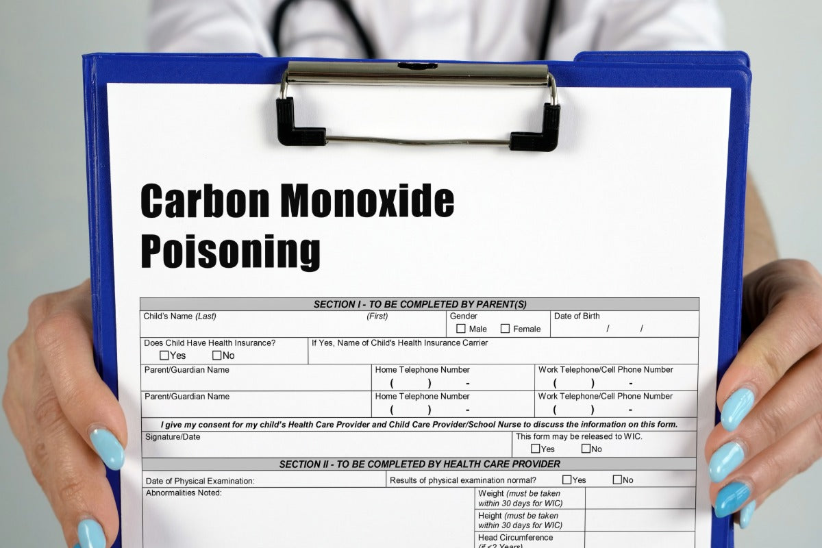 A docter handing a carbon monoxide health for to a parent to fill out for their child. 