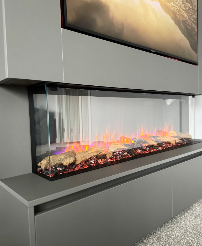 Modern electric fireplace with glass front and TV above in a gray room.